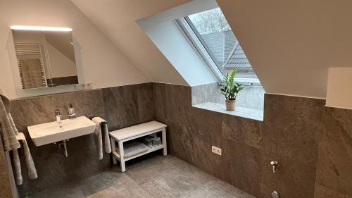 a bathroom with a sink and a window at Apartment Hof Düker, 2 Komfort DZ, Design Bad in Gütersloh