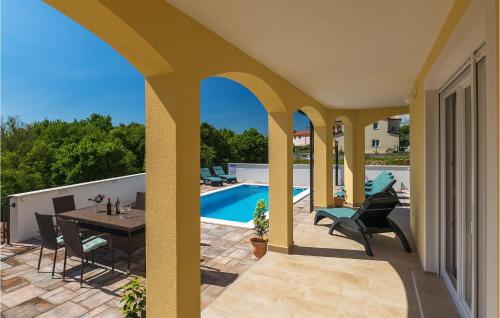 a patio with a table and chairs and a swimming pool at Villa Florami in Pula