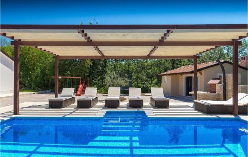 una piscina con padiglione con sedie a sdraio e piscina di Villa Funcici a Lovrinići
