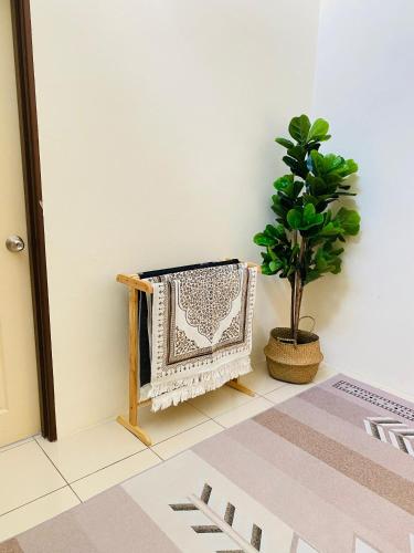 a living room with a radiator and a potted plant at Ila Homestay in Senawang