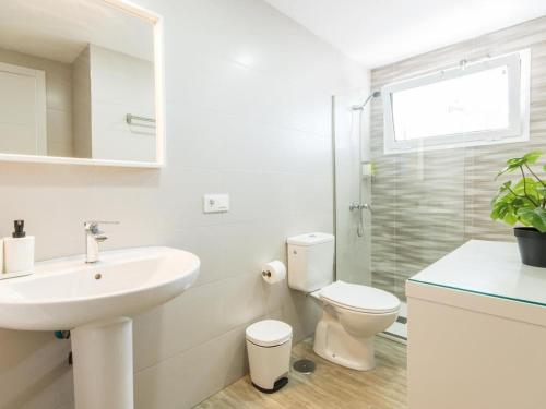 a white bathroom with a sink and a toilet at Apartamento Altamira Beach in Tías