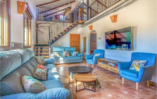 a living room with a blue couch and chairs at Gorgeous Home In Cartagena in Fuente-Álamo de Murcia