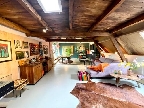 a living room with a couch and a table at Appartement Zeezicht in Leeuwarden
