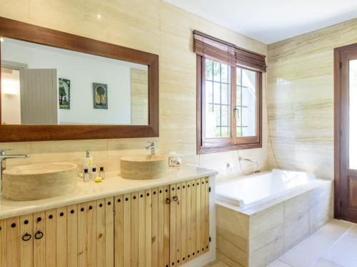 a bathroom with two sinks and a bath tub and a tubermott at Farmhouse in Ibiza with Bali Pavilion in Santa Gertrudis de Fruitera