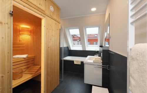 a bathroom with a sink and a bath tub at Baltischer Hof Apartment 57 in Boltenhagen