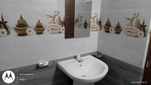 a bathroom with a toilet and a mirror and a sink at Anuhas Family Resort & Water House in Anuradhapura
