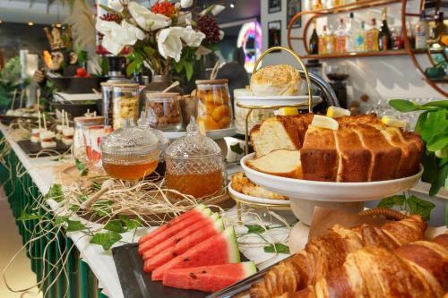 a buffet of bread and fruit on a table at Luff Living - Adult Only 12 Plus in Antalya
