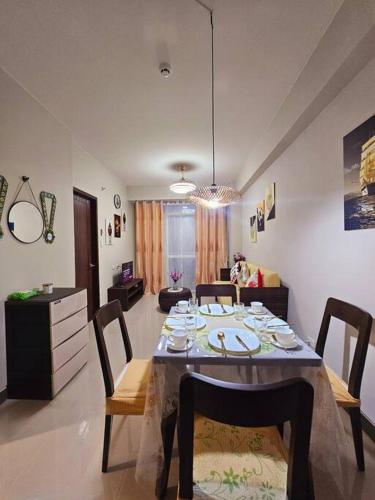 a dining room with a table and a living room at Evelyn's Azure Escapes at Boracay Newcoast in Boracay