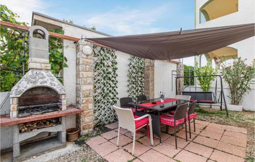 a patio with a table and a brick oven at Stunning Apartment In Krusevo With Wifi in Kruševo