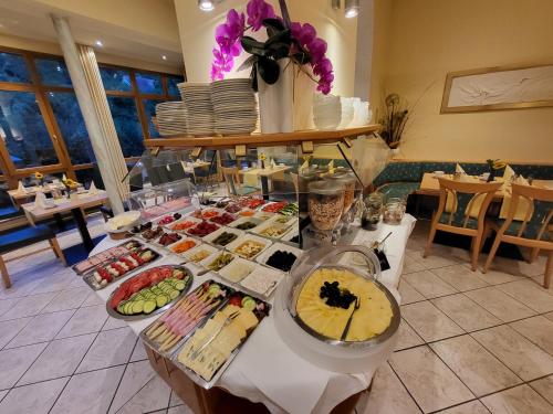 a buffet of food on a table in a restaurant at Hotel Donaublick in Scheer