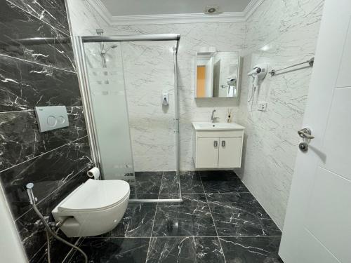 a bathroom with a toilet and a shower and a sink at One Suit in Kartepe