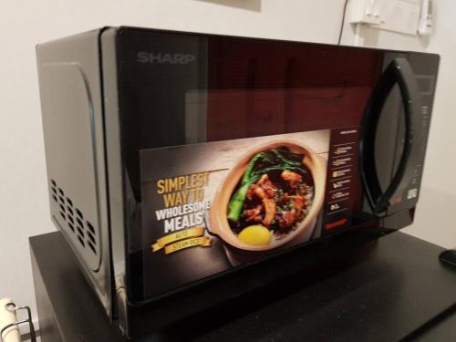 a microwave with a picture of a bowl of food in it at Heritage Studio in UNESCO Zone near to StreetArt & Town 1 in George Town