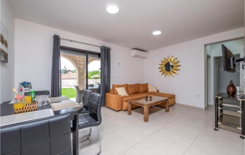 a living room with a couch and a table at 2 Bedroom Nice Apartment In Medulin in Medulin