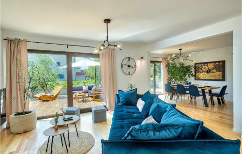 a living room with a blue couch and a table at Villa Suncica in Sukošan