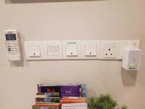 a shelf with a phone and books on a wall at Heritage Studio in UNESCO Zone near to StreetArt & Town 2 in George Town