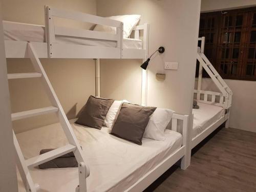 a bedroom with two bunk beds and a lamp at Heritage Studio in UNESCO Zone near to StreetArt & Town 2 in George Town