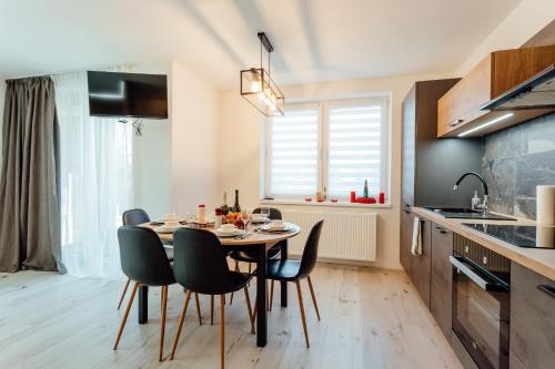 a dining room with a table and chairs in a kitchen at Miracle Seasons in Liptovský Mikuláš