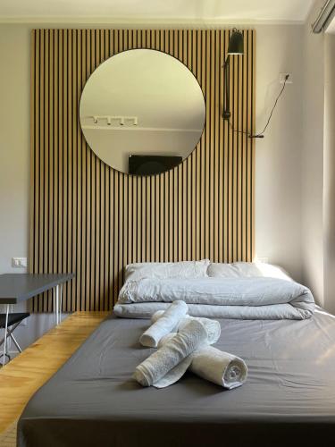 a bedroom with a bed with a mirror on the wall at Little Milan - LM2 - LM3 - LM4 in Milan