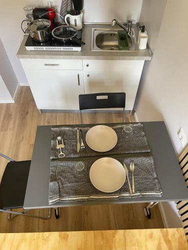 a kitchen with a table with plates and utensils on it at Little Milan - LM2 - LM3 - LM4 in Milan