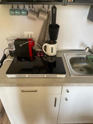 a kitchen counter with a coffee maker and a sink at Little Milan - LM2 - LM3 - LM4 in Milan
