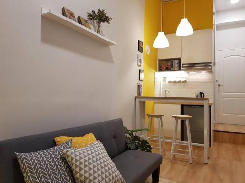 a living room with a couch and a kitchen at Heritage Loft on Beach Street near UNESCO Zone & Street Art 1 in George Town