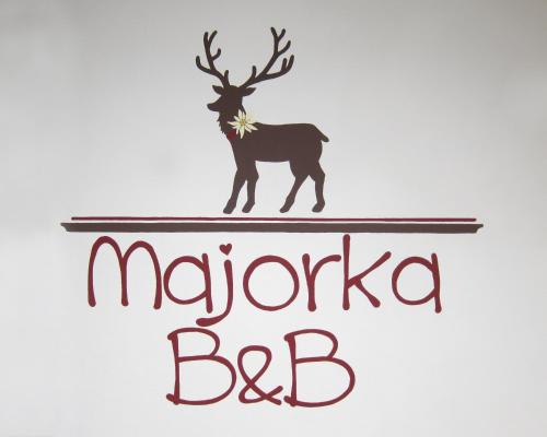 a sign for a restaurant with a moose and the words navratica bc at Albergo Majorka in Canazei