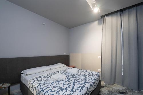 a bedroom with a bed with two stuffed animals on it at Mia Suites Hotel Bella Capri in Naples