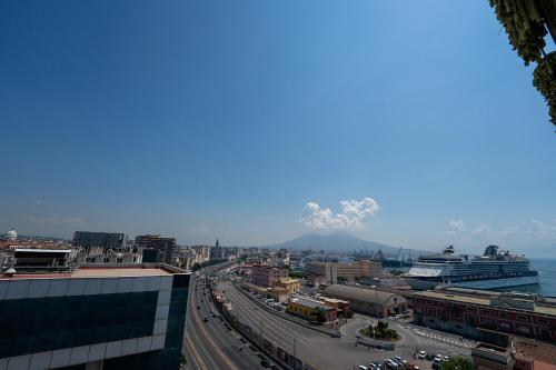 a view of a city with the ocean and mountains at Mia Suites Hotel Bella Capri in Naples