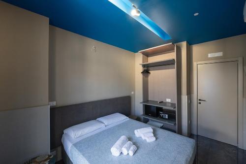 a bedroom with a bed with two towels on it at Mia Suites Hotel Bella Capri in Naples
