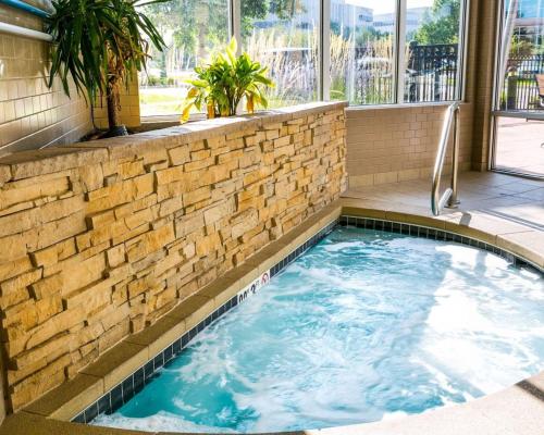 a large swimming pool with a brick wall at Cambria Hotel Denver International Airport in Aurora