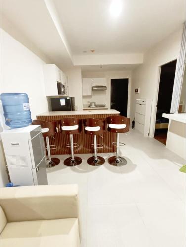a kitchen with a counter and stools in a room at Matina Enclaves 2BR with Wifi Near SM Mall in Davao City