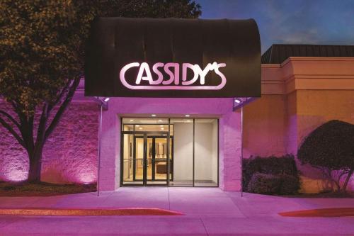 a building with an asx sign on the front at Radisson Hotel Fort Worth North-Fossil Creek in Fort Worth
