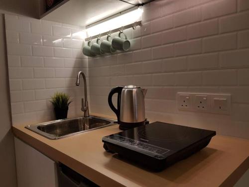 a kitchen with a sink and a coffee maker on the counter at Heritage Loft on Beach Street near UNESCO Zone & Street Art 2 in George Town