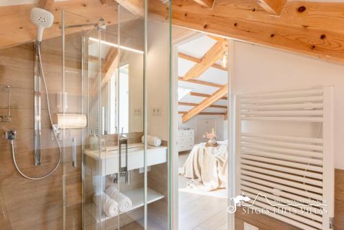 a bathroom with a shower and a glass wall at Villa De Los Leones in heart of Sitges by Beach and Town with A/C and Games in Sitges