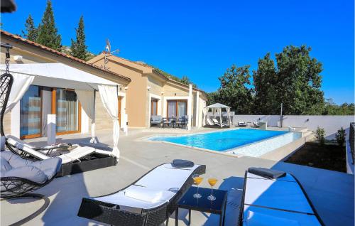 a villa with a swimming pool and a house at Awesome Home In Starigrad Paklenica in Starigrad-Paklenica