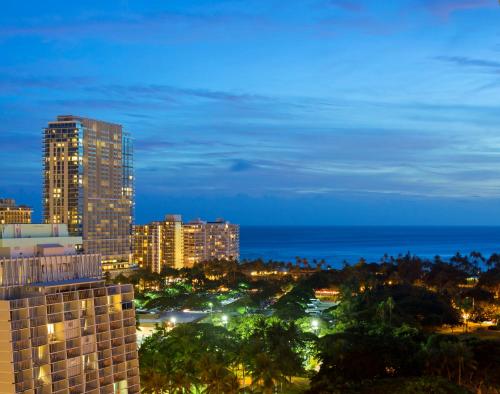 a view of a city skyline at night at Romer Waikiki at The Ambassador in Honolulu