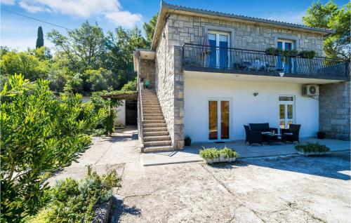 a stone house with a balcony and a patio at Gorgeous Apartment In Gruda With Wifi in Gruda