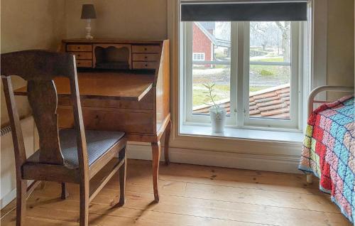 a desk with a chair next to a window at 4 Bedroom Lovely Home In Lammhult in Lammhult