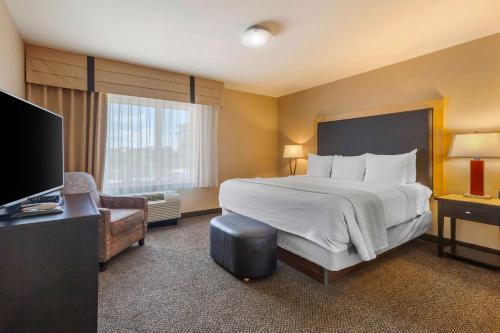 a hotel room with a bed and a television at Cambria Hotel Ft Collins in Fort Collins