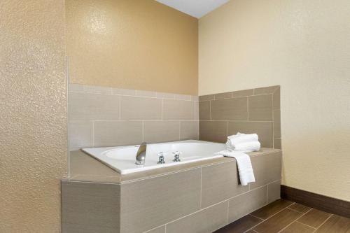 a bathroom with a bath tub in a room at Comfort Inn & Suites Greeley in Greeley