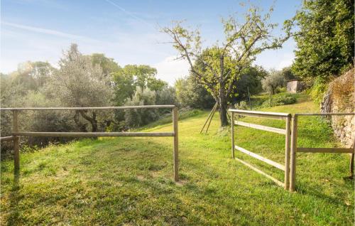 a wooden fence in a field with trees at Cozy Apartment In Castell'anselmo in Castell’Anselmo
