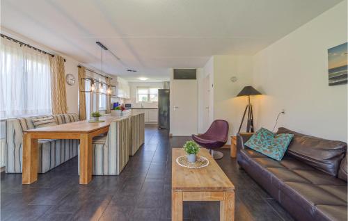 a living room with a couch and a table at Beautiful Home In Wemeldinge With Wifi in Wemeldinge
