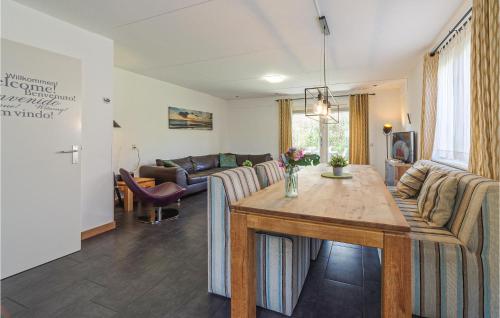 a living room with a table and a couch at Beautiful Home In Wemeldinge With Wifi in Wemeldinge