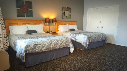 a hotel room with two beds in a room at Garden View Inn in Fresno