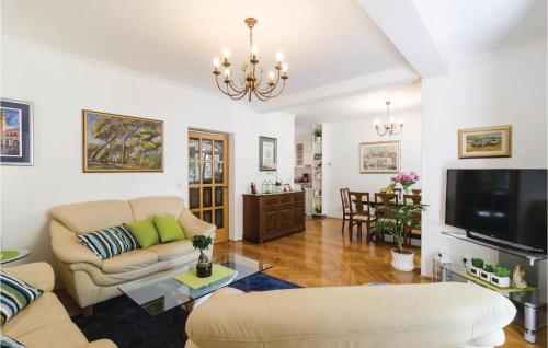 a living room with two couches and a tv at Holiday Home Obuljeno Donje Iii in Mokošica