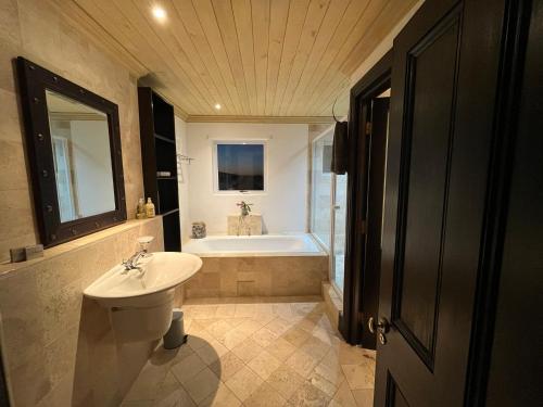 a bathroom with a sink and a bath tub at LaShack in Langebaan