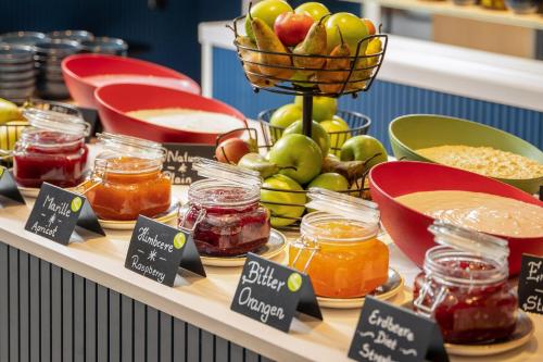 a display of fruits and vegetables and jars of food at INNSiDE by Meliá Berlin Mitte in Berlin