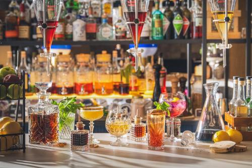 a bar with many different types of glasses on a counter at INNSiDE by Meliá Berlin Mitte in Berlin
