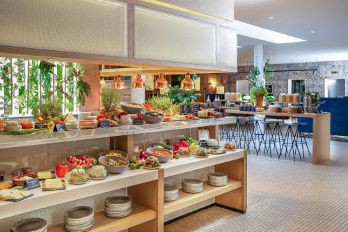 a buffet line with a lot of food on display at INNSiDE by Meliá Berlin Mitte in Berlin