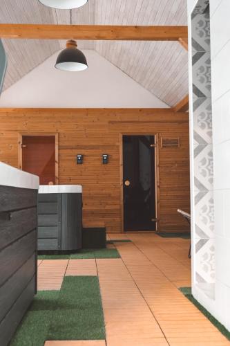 an outdoor kitchen with wooden walls and a ceiling at Kardamom Studio Apartman in Szigliget